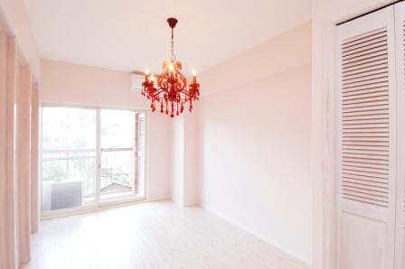 洋室はベビーピンクの壁に赤いシャンデリアの個性的な空間に