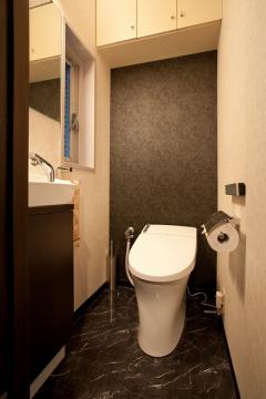 トイレ壁紙は、白をベースに奥の1面だけを同じ柄の黒に。
